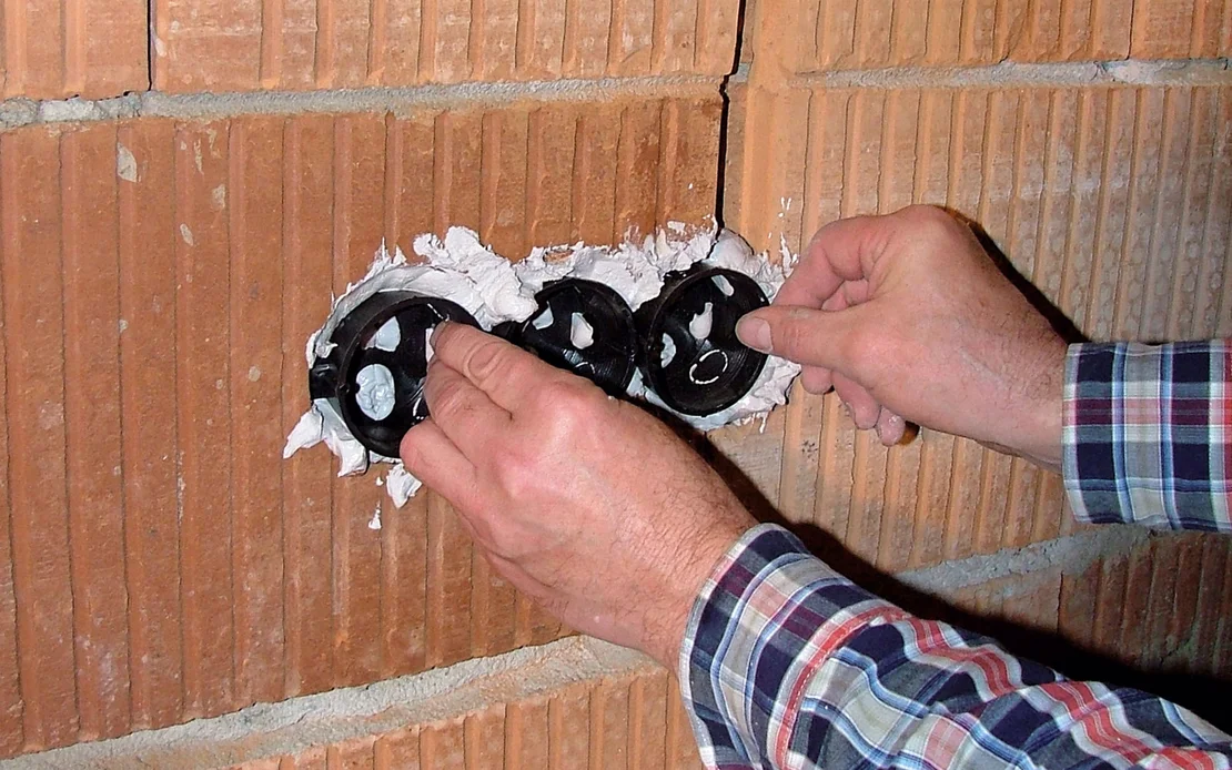 Einbau von Unterputzdosen in eine Ziegelwand f&uuml;r Elektroinstallationen.